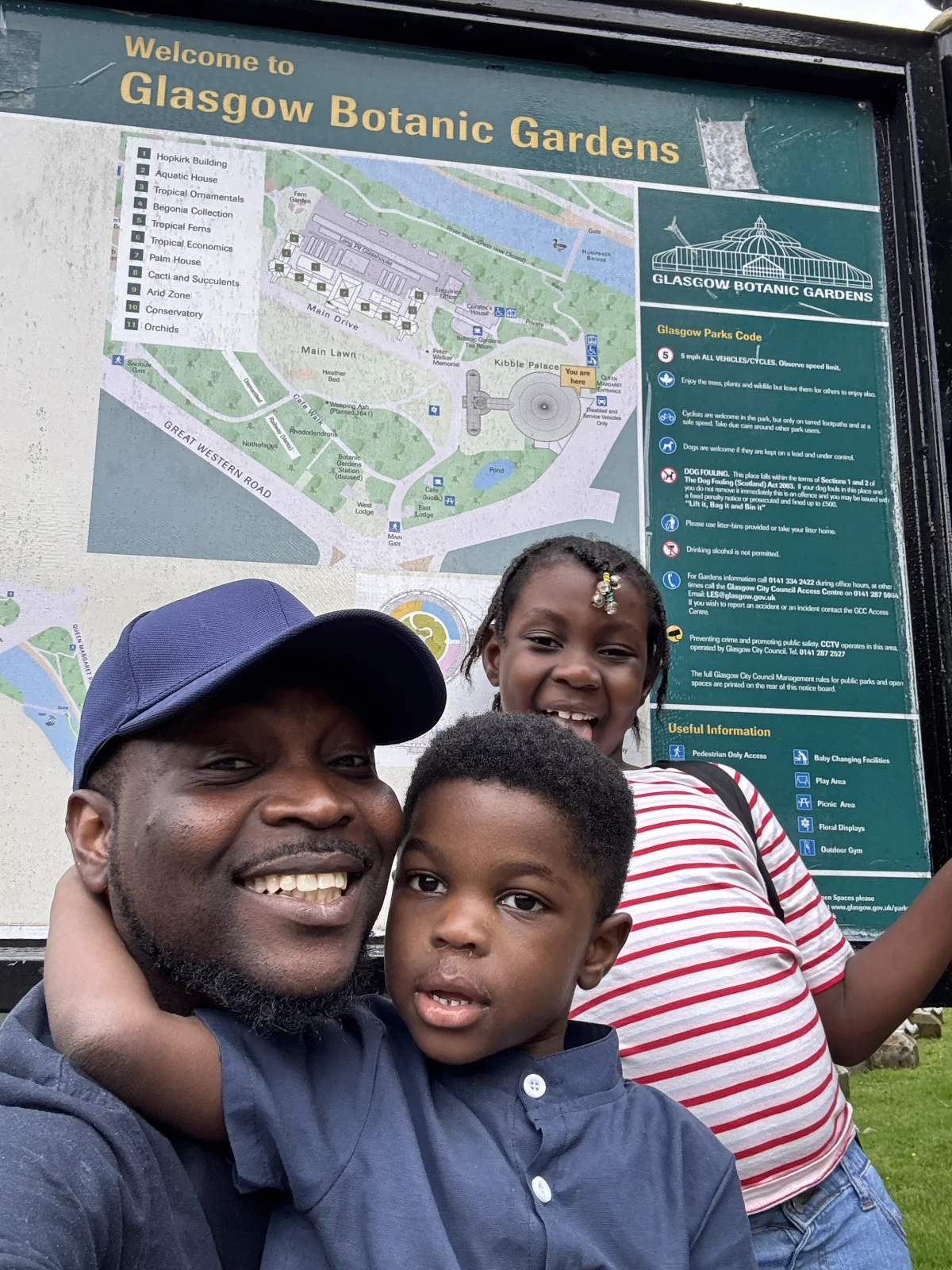 Dayo with his two children at Glasgow Botanic Gardens